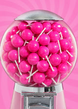 Glass candy dispenser filled with bright pink It Girl beauty lollipops against a pink swirl background.